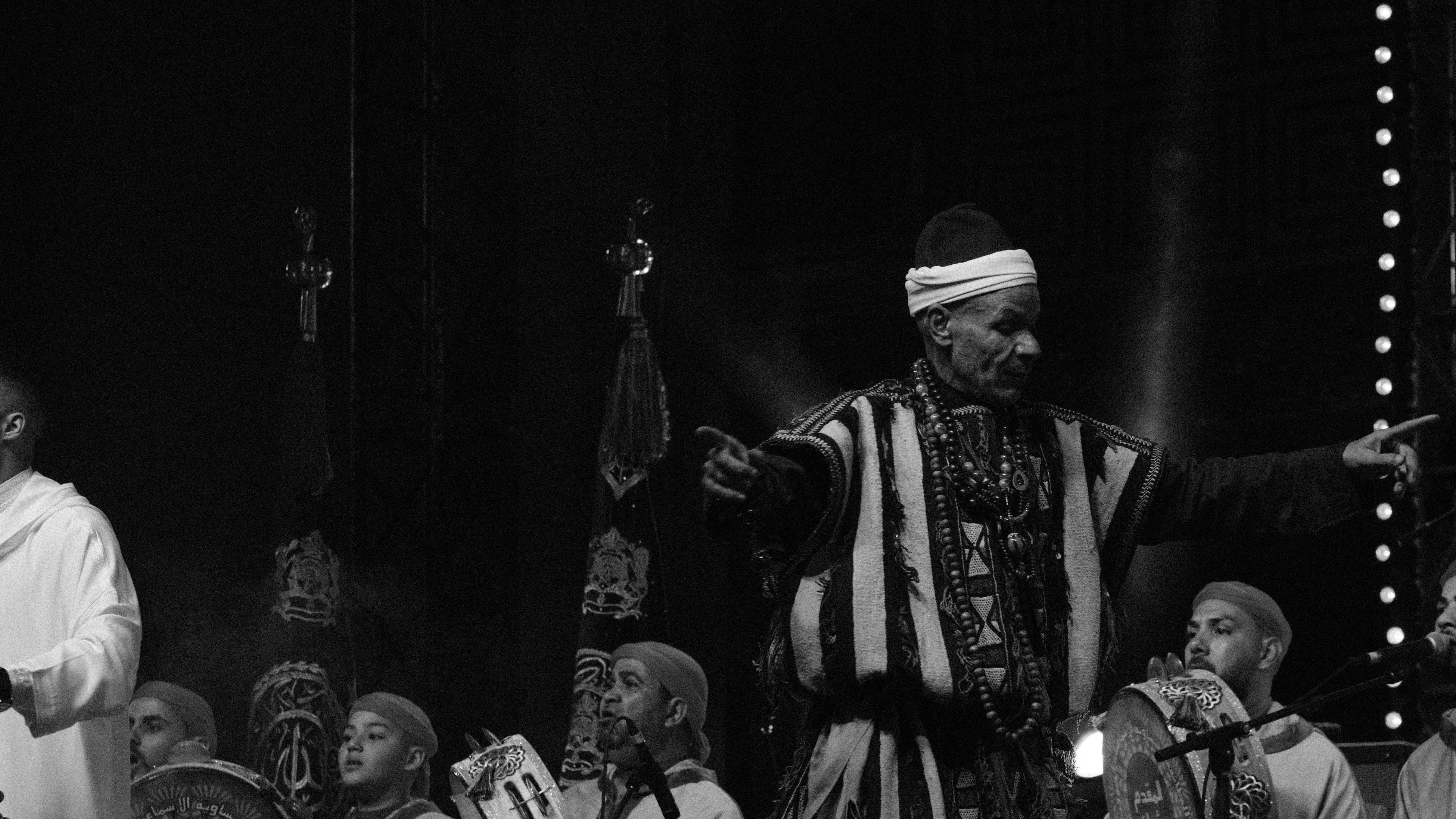 Black and white cultural performer addressing audience