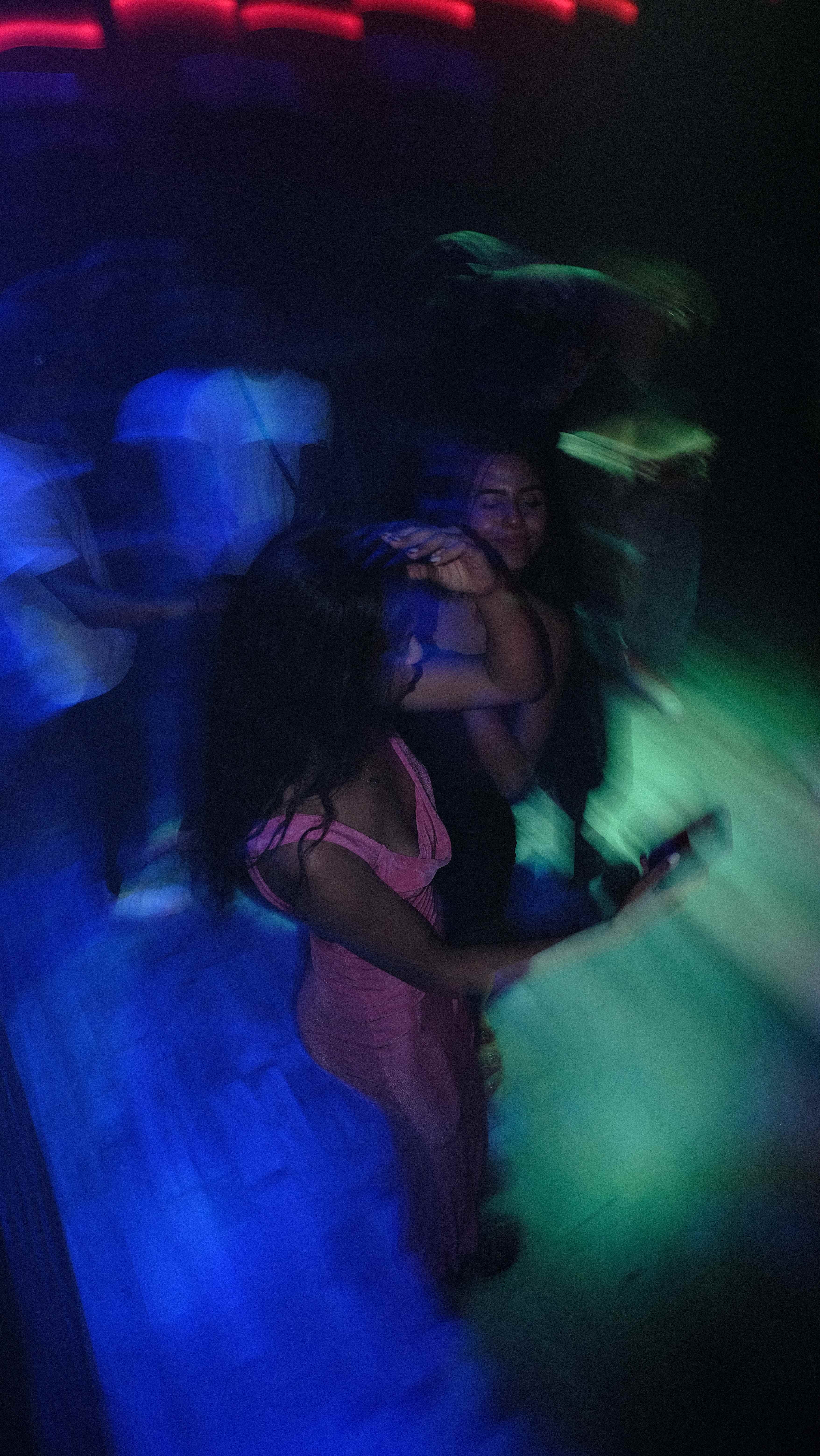 Nightclub dancers with motion blur and colorful lighting