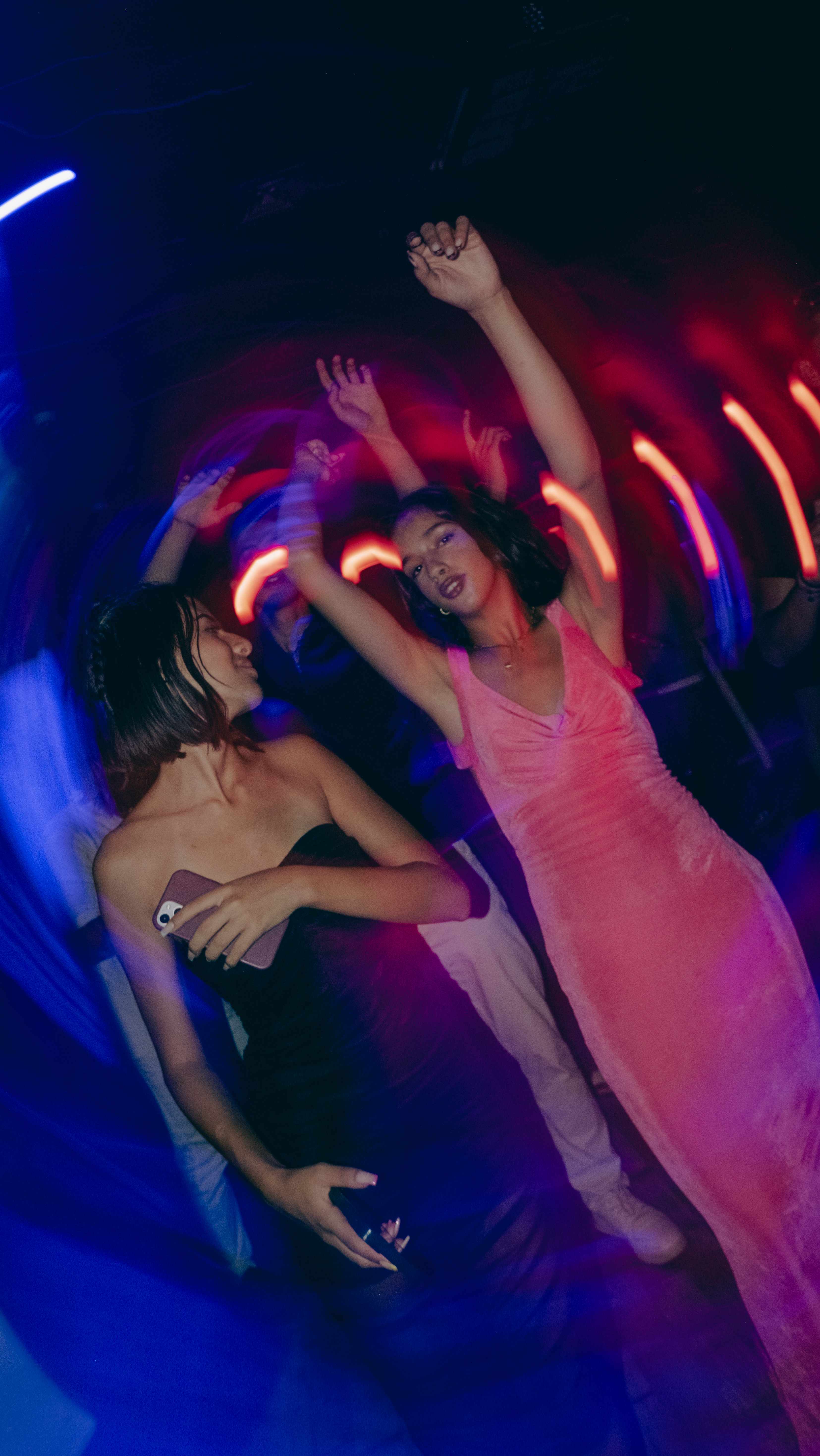 Event photography - people dancing with colorful lights