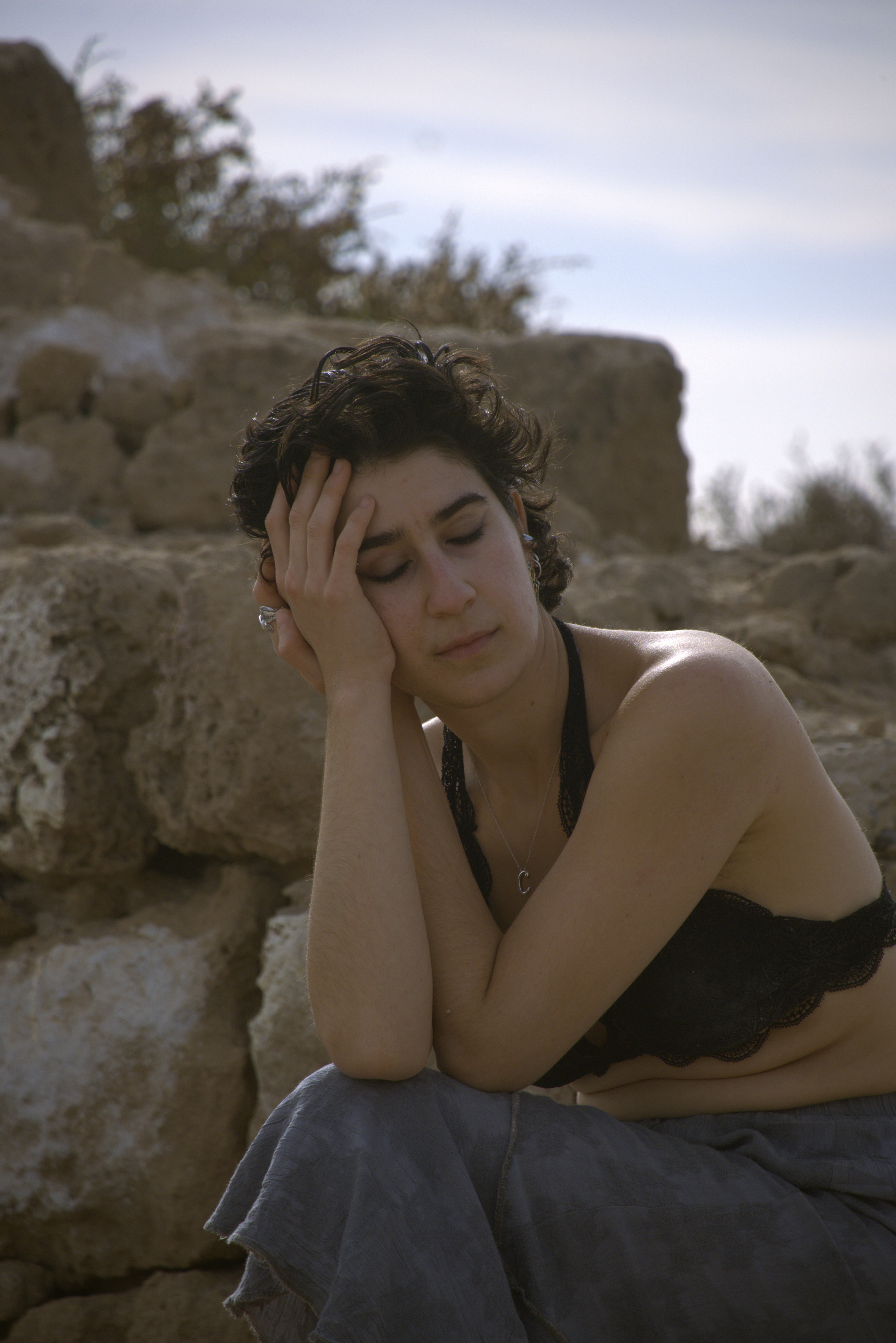 Intimate portrait of contemplative woman with curly hair