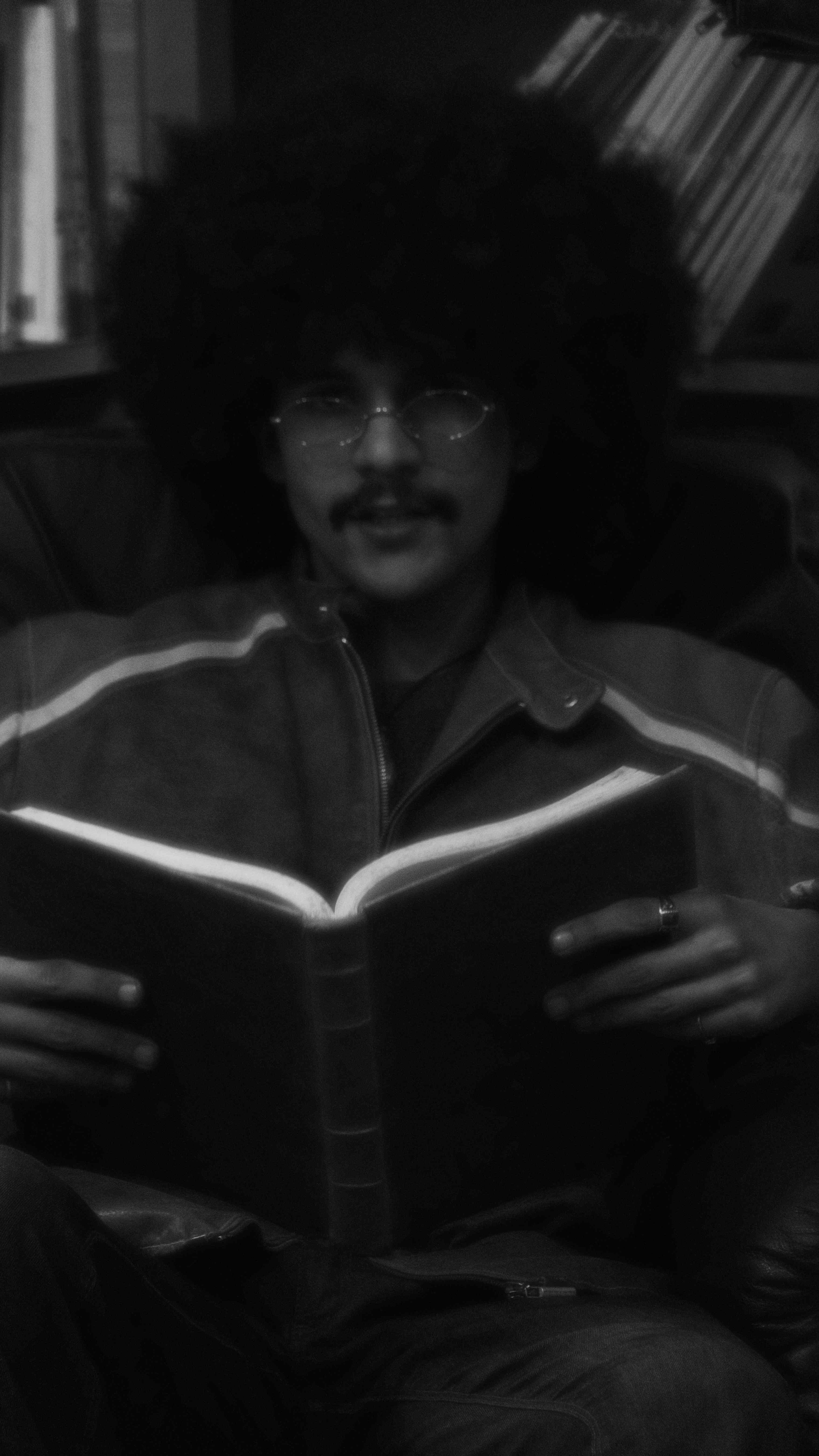 Atmospheric black and white portrait of person reading