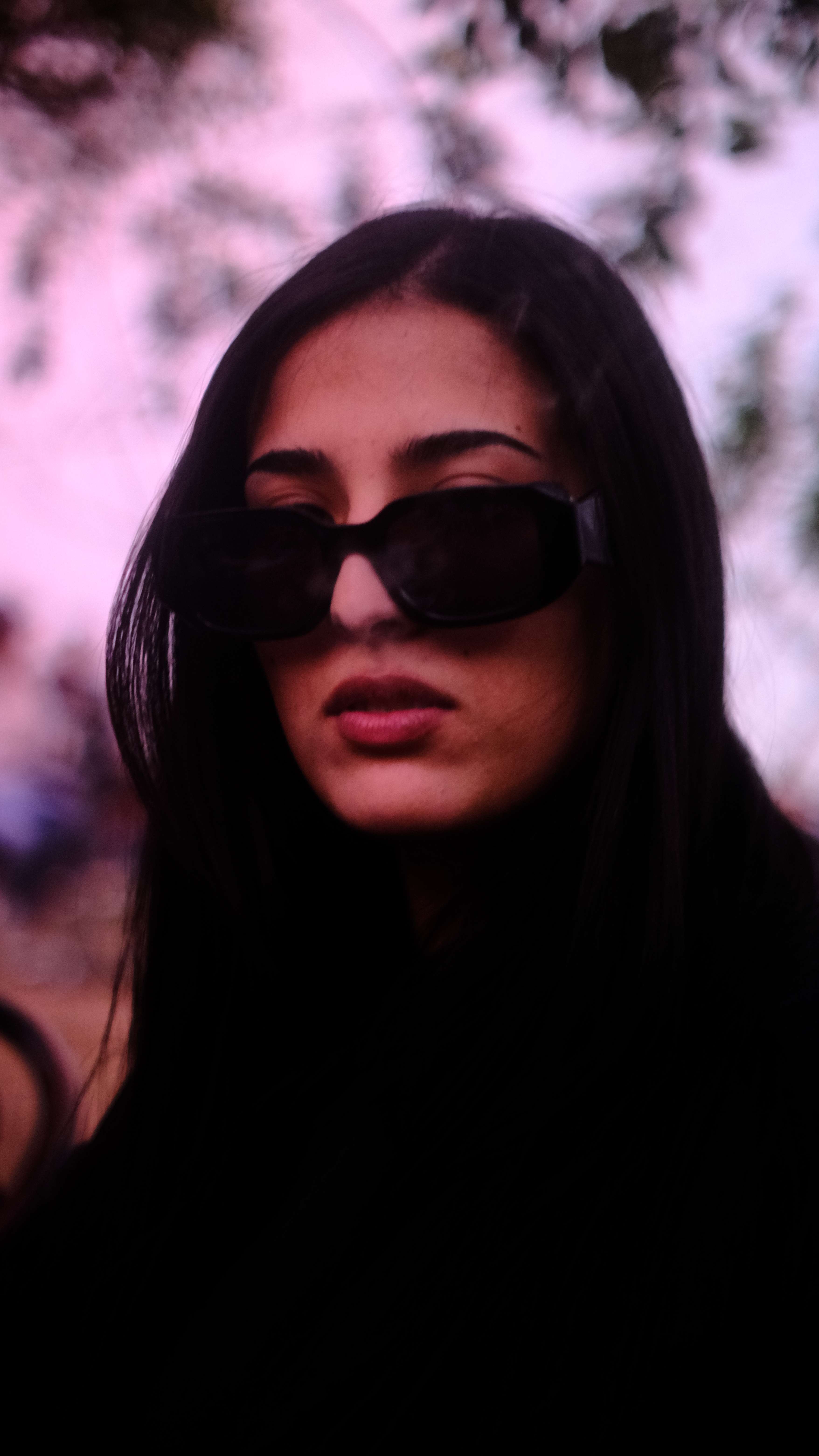 Stylish portrait of woman with sunglasses in warm lighting