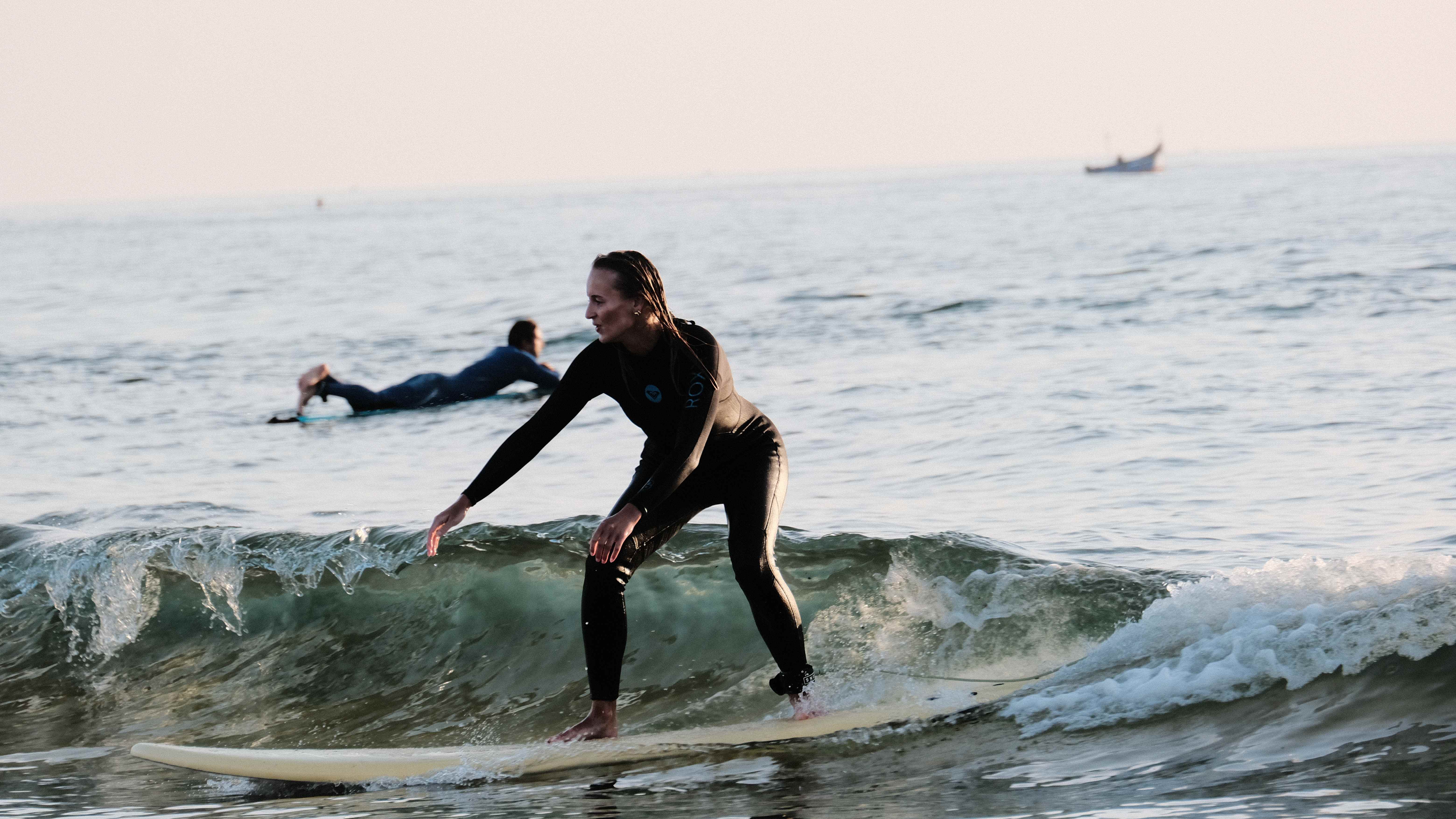 Female surfer during golden hour lighting