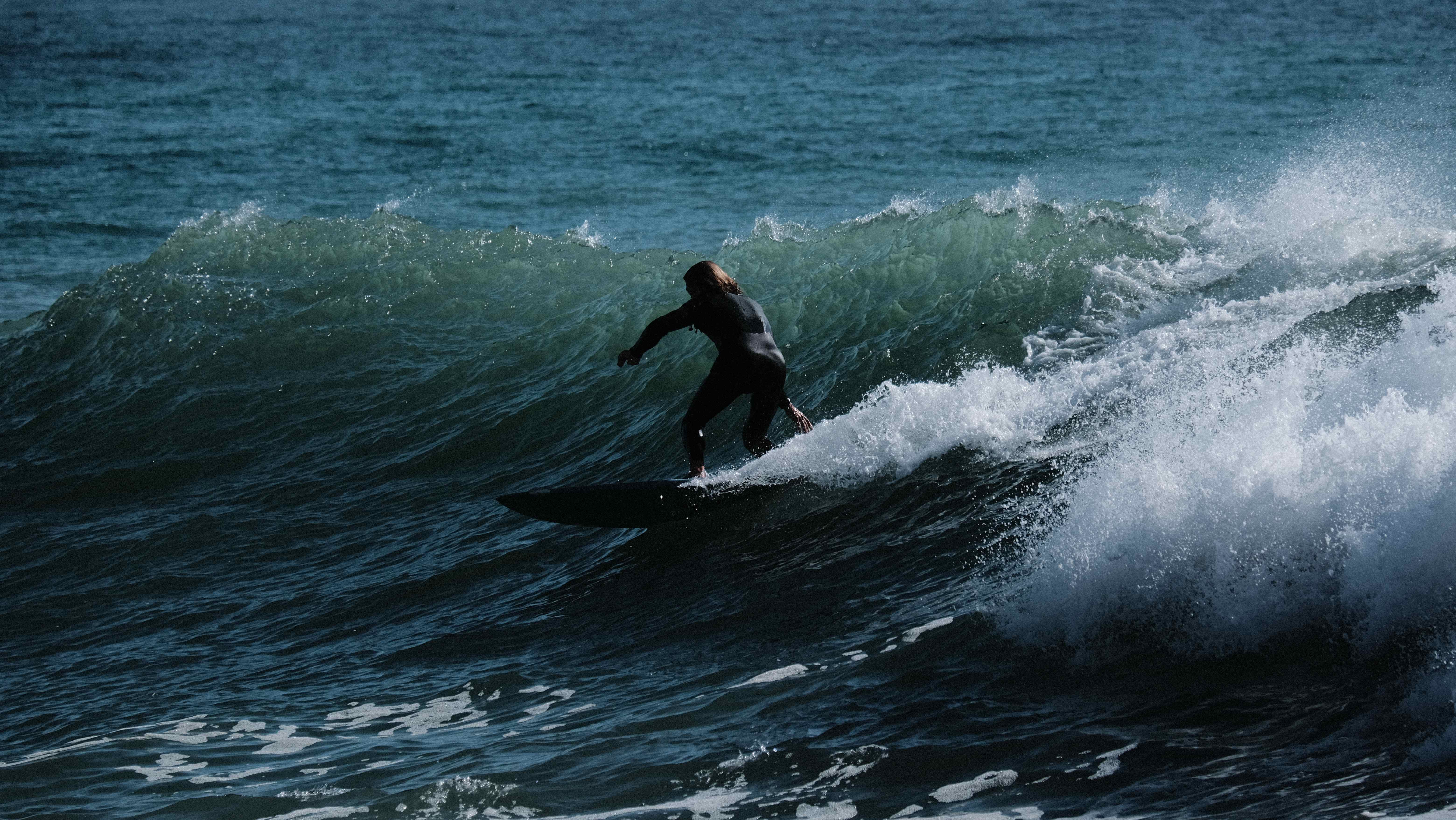 Surfer on powerful wave with dramatic water spray